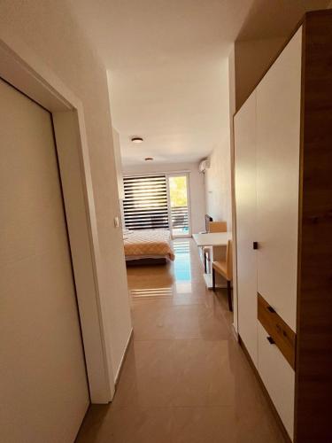 a hallway of a bedroom with a bed and a desk at Prenociste BONANCA in Veliko Gradište