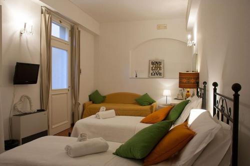 a bedroom with two beds with green and white at Cosy House in Florence