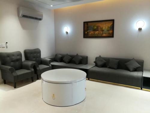 a living room with couches and a coffee table at Maskan in Islamabad