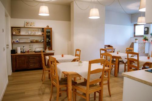 a restaurant with tables and chairs in a room at B&B Gianchia in Brentino Belluno