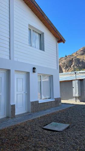 a white house with a skateboard in front of it at MAITEN Esquel in Esquel