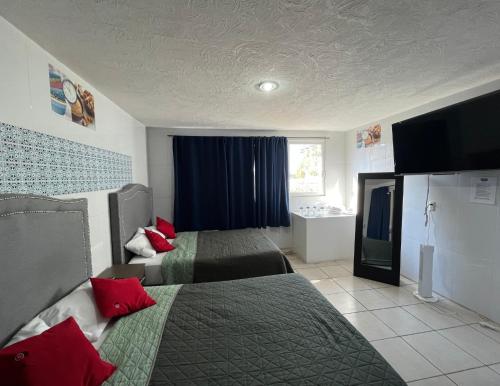 a hotel room with two beds and a television at 4 VENATOR House Boutique in León