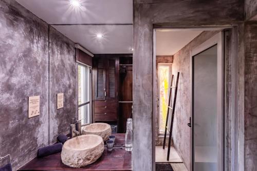 a bathroom with two large sinks in a room at Vida Silvestre in Tulum