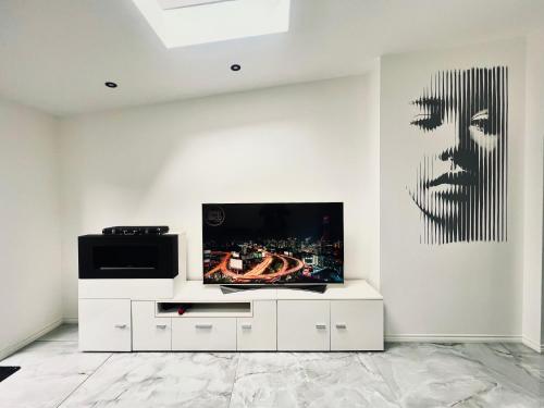 a living room with a flat screen tv on a wall at Nirvana in Manchester