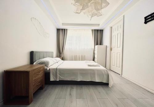 a bedroom with a bed and a dresser and a window at Nirvana in Manchester