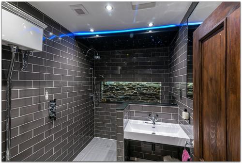 a bathroom with a sink and a mirror at Broadoaks Boutique Country House in Windermere