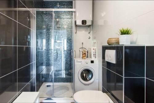 a bathroom with a washing machine in a shower at House Matenda house in Solin