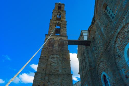 a tall clock tower on the side of a building at Endless Green 4 Arethousa Ikaria in Arethousa