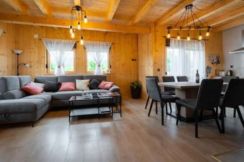 a living room with a couch and a table at Kuća za odmor Butković in Mrkopalj