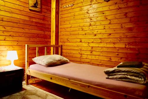 a bedroom with a bed in a wooden wall at U6 Schöpfwerk Hostel 1 in Vienna