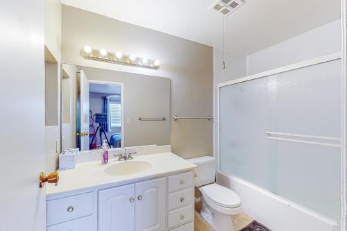 a bathroom with a sink and a toilet and a mirror at Cozy Hideout in Scottsdale