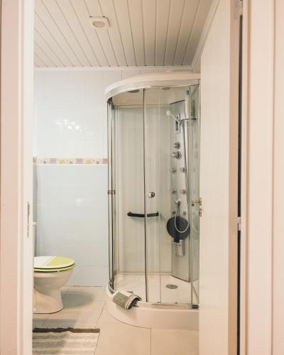 a glass shower in a bathroom with a toilet at Costanova Surfhouse in Ílhavo