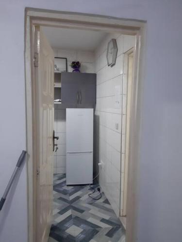 a kitchen with a white refrigerator in a room at Lovely 1-bedroom rental unit for short stays. in Tema