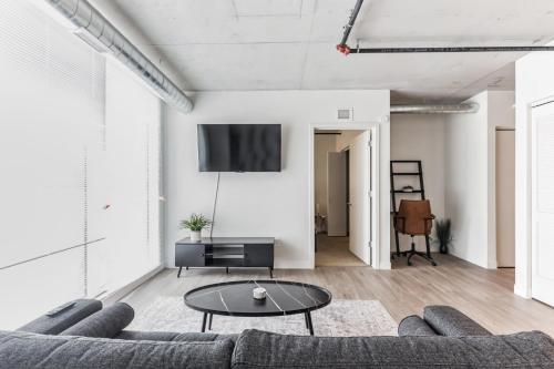 a living room with a couch and a table at DT Delight Downtown Living Two-Bedroom Endless Access in Cleveland