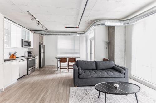 a living room with a couch and a table at DT Delight Downtown Living Two-Bedroom Endless Access in Cleveland