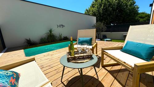 a patio with a table with a cake and candles at DAYA LODGE. in LʼIsle-sur-la-Sorgue