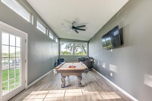 a room with a pool table and a ceiling fan at Dock, Kayaks, Game Room Lakefront Antioch Home! in Antioch