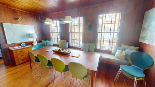 a dining room with a wooden table and chairs at 3 10th Place by Tybee Vacation Rentals in Tybee Island