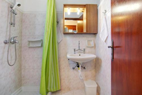 a bathroom with a sink and a shower at Areti Orfeas Studios in Vasilikos