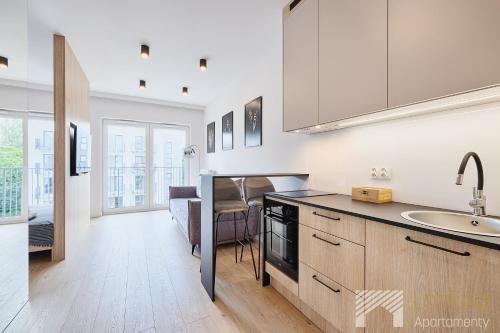 a kitchen with a sink and a counter top at Boho Prestige by LookAp in Łódź