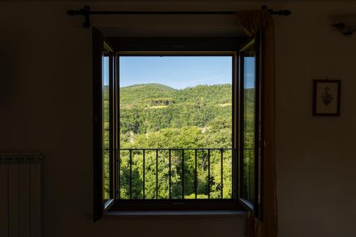 a window with a view of a mountain view at Relais Parco Del Subasio in Piano Delle Pieve