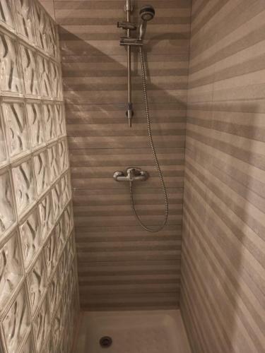 a bathroom with a shower with a shower head at Pueblo Evita Hill in Benalmádena