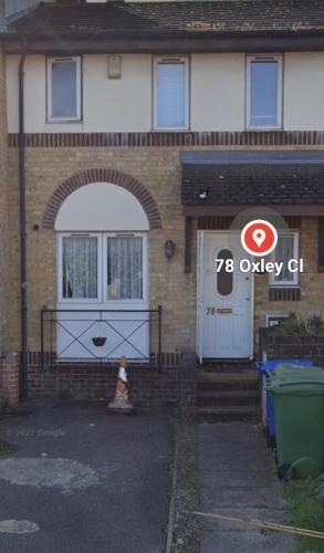 a house with a garage and a dog in front of it at City Guest House se1 in London