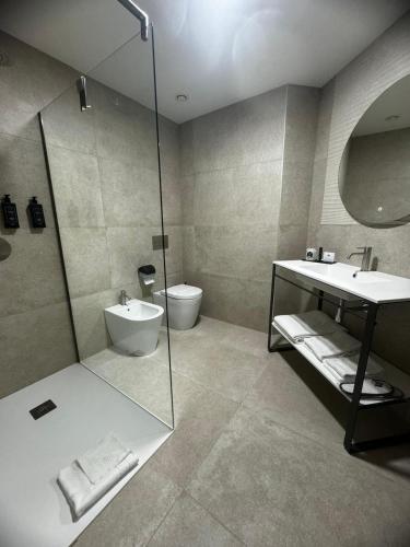 a bathroom with a shower and a sink and a toilet at Acca Sporting Milano - AA Hotels in Opera