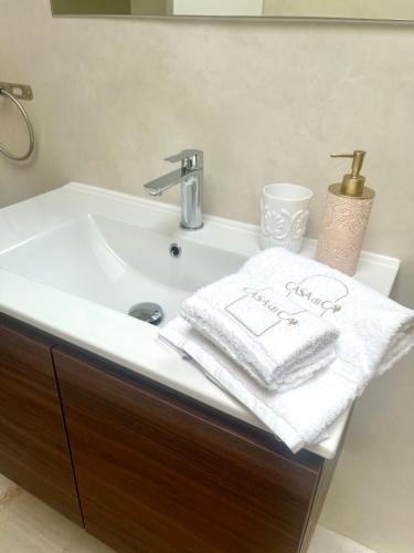 a bathroom sink with a white towel on it at Casa di Ca Rooms in Squinzano