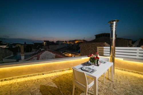 a table and chairs on a balcony with a view at Jacuzzi Suite In The Heart Of OldTown in Rethymno