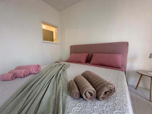 a bedroom with a bed with towels on it at Stintino vista mare l'ancora in Stintino