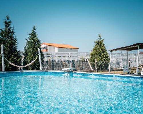 a large swimming pool with a slide and a playground at Costanova Surfhouse in Ílhavo