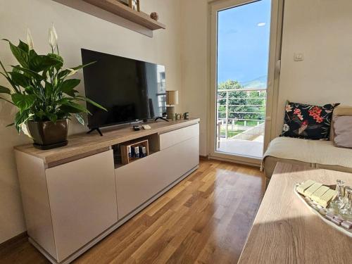 a living room with a large flat screen tv at Blanc in Podgorica