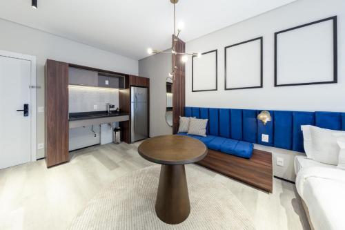 a living room with a table and a couch at Charlie On The Parc Ibirapuera Hotel in Sao Paulo