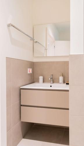 a bathroom with a sink and a mirror at Le Pergole Aloha - Menaggio by LoveComo in Menaggio