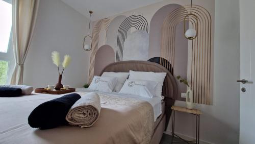 a bedroom with a large bed with white pillows at Luxury apartment Terracotta Sun with private Jacuzzi and Garden in Novalja
