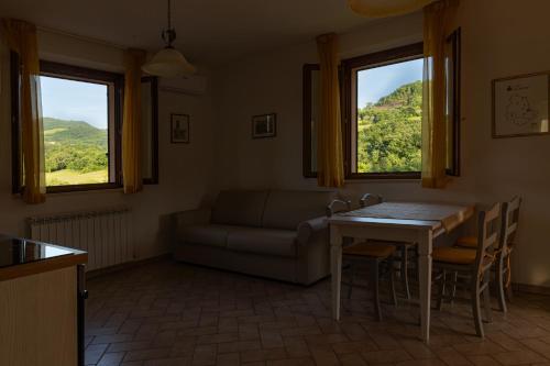 a living room with a couch and a table at Relais Parco Del Subasio in Piano Delle Pieve
