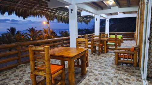 a restaurant with tables and chairs and a view of the ocean at Casa Gaia Paradise in Mompiche