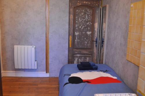a bedroom with a bed in a room with a door at Appt 5mins to Paris Gare de Lyon with terrace in Maisons-Alfort