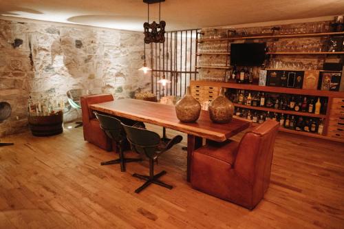a dining room with a wooden table and chairs at María & Bernardo Casa - Viñedo in El Coyote