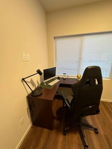 an office with a computer desk and a chair at Comfortable lifestyle Townhouse in Monroe