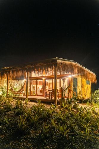 a house that is lit up at night at Soledade Bangalôs - Kauli Seadi in Macau