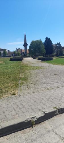 a park with a monument in the middle of a field at Stan na dan -Bratunac- in Bratunac