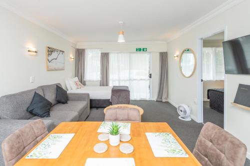 a living room with a couch and a table at Kings Court Motel in Whanganui