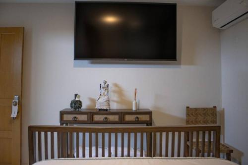 a bedroom with a flat screen tv on the wall at Casa Nawuales - Terraza - Guadalajara céntrico in Guadalajara