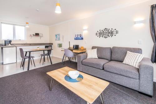 a living room with a couch and a table at Kings Court Motel in Whanganui