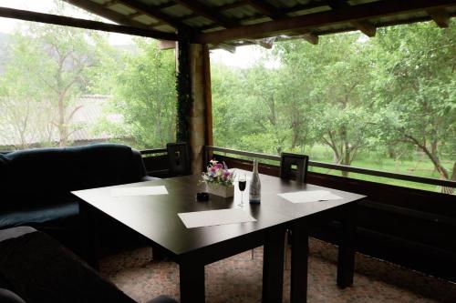 a table with flowers on it in front of a window at TheRefuge in Curtea de Argeş