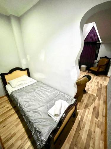 a small bed in a room with at B&B Europa Hotel in Kutaisi