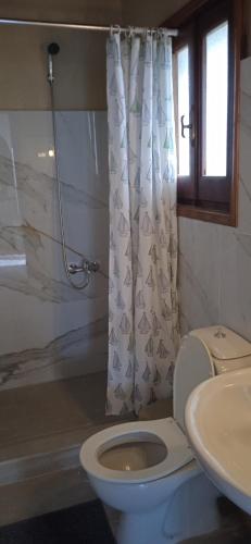 a bathroom with a toilet and a sink at EKTOR APARTMENTS @SWIMMING POOL in Sidari