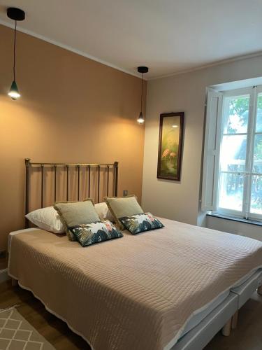 a bedroom with a large bed with two pillows at La Maison de Auguste in Coursan